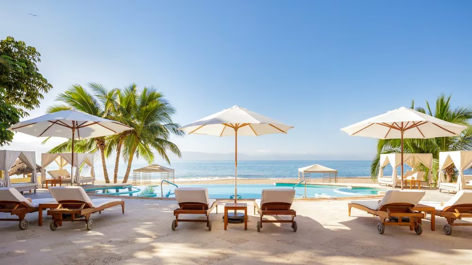 Casa Velas adults-only resort in Puerto Vallarta with pool, palms, and tropical gardens